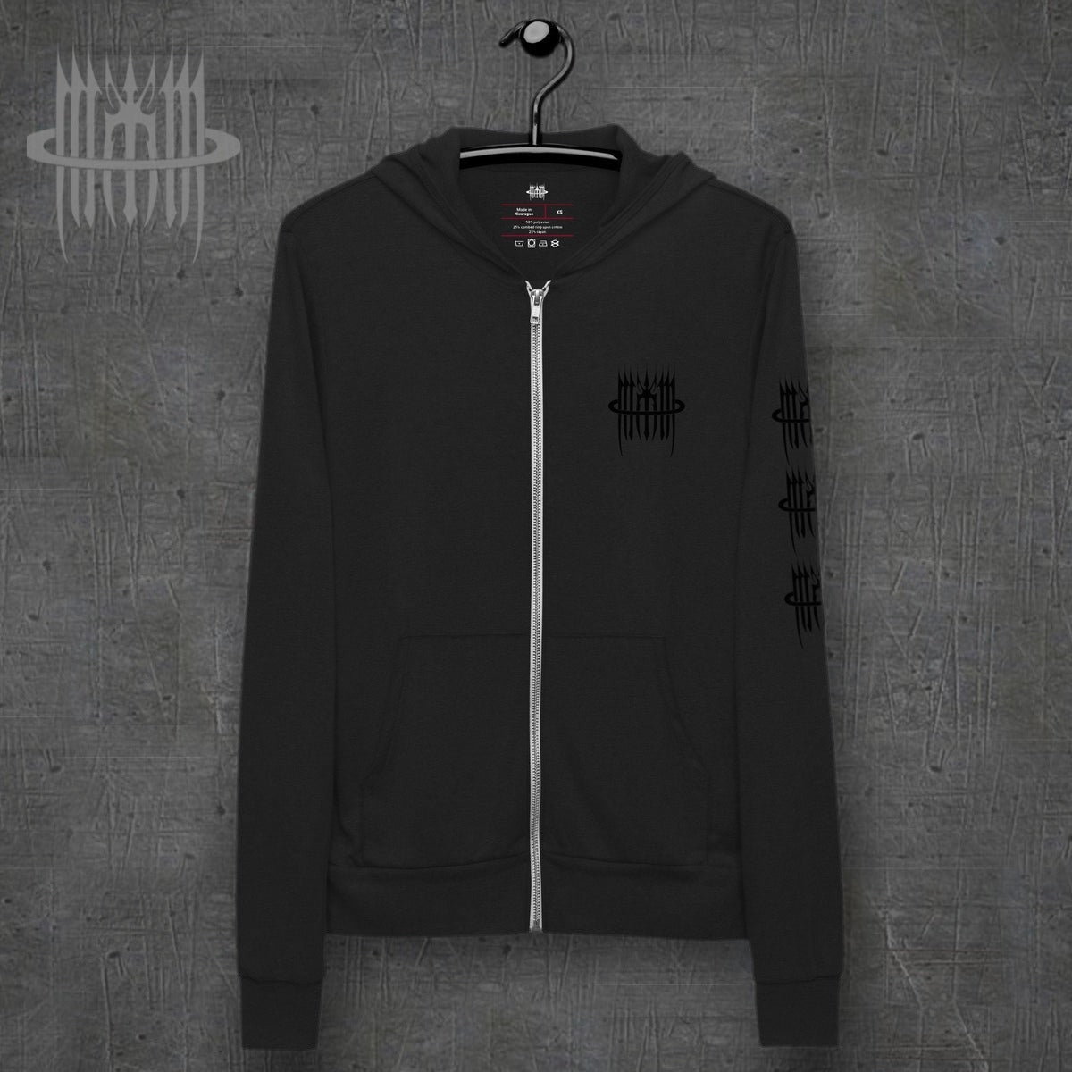 MK0KM Unisex xxx zip hoodie – front view, dark concrete background